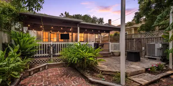 Image 2: String lighting, a covered deck, and a spacious br