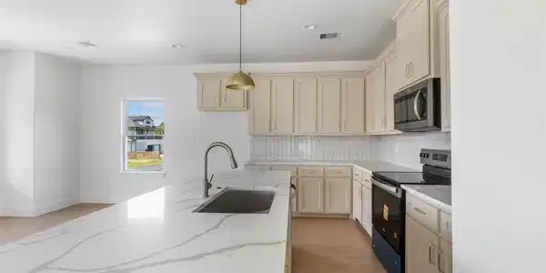 Image 4: Large island with elegant quartz countertops.