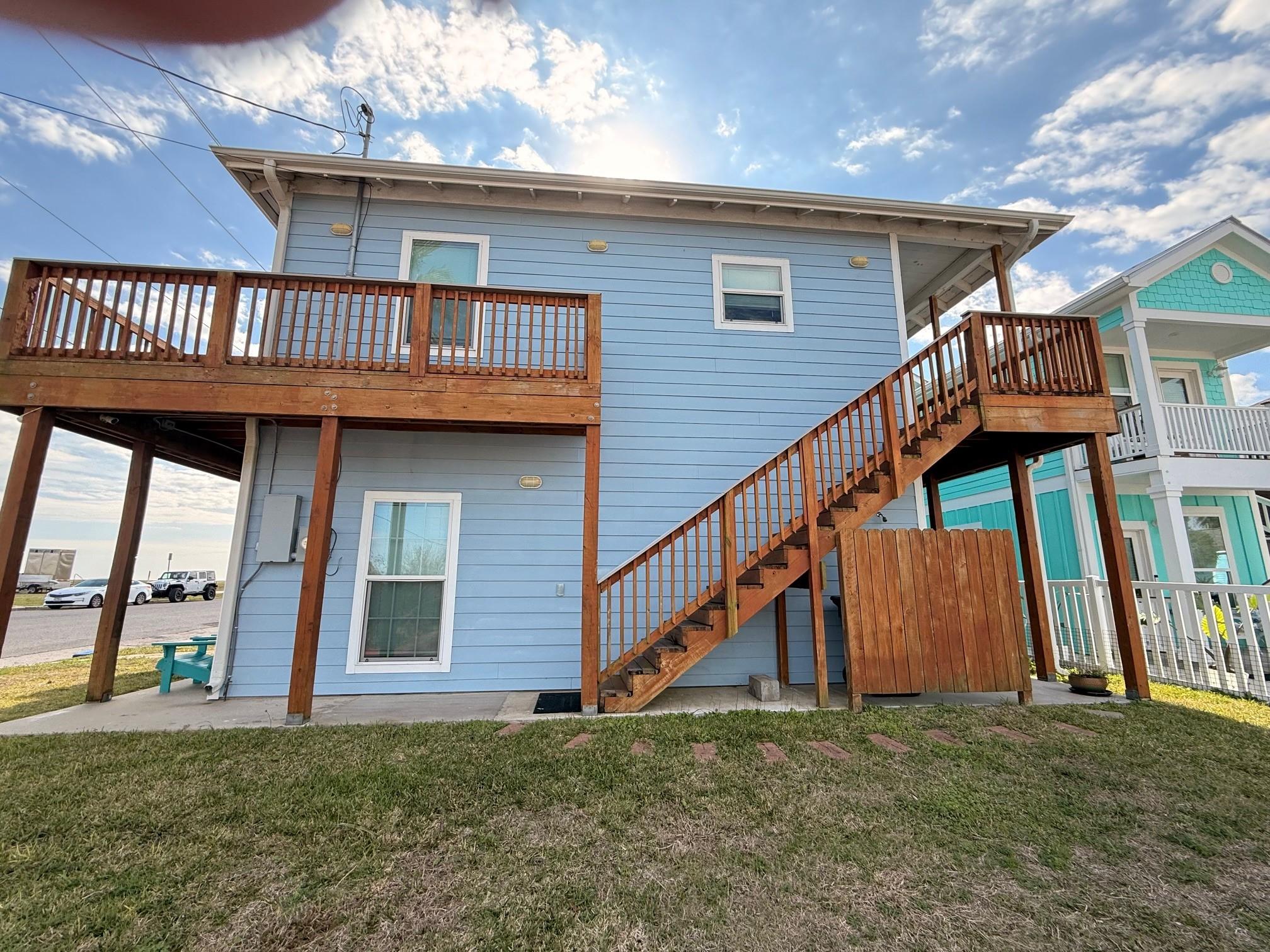 Image 2: This charming two-story home features a light blue