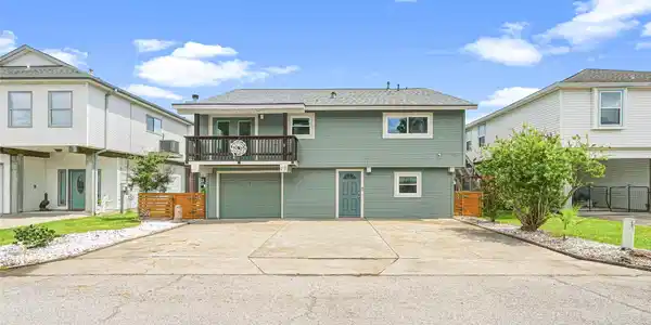 Image 2: Charming two-story home with an inviting balcony,