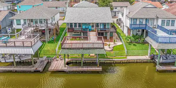 Image 3: This waterfront home has a spacious deck overlooki