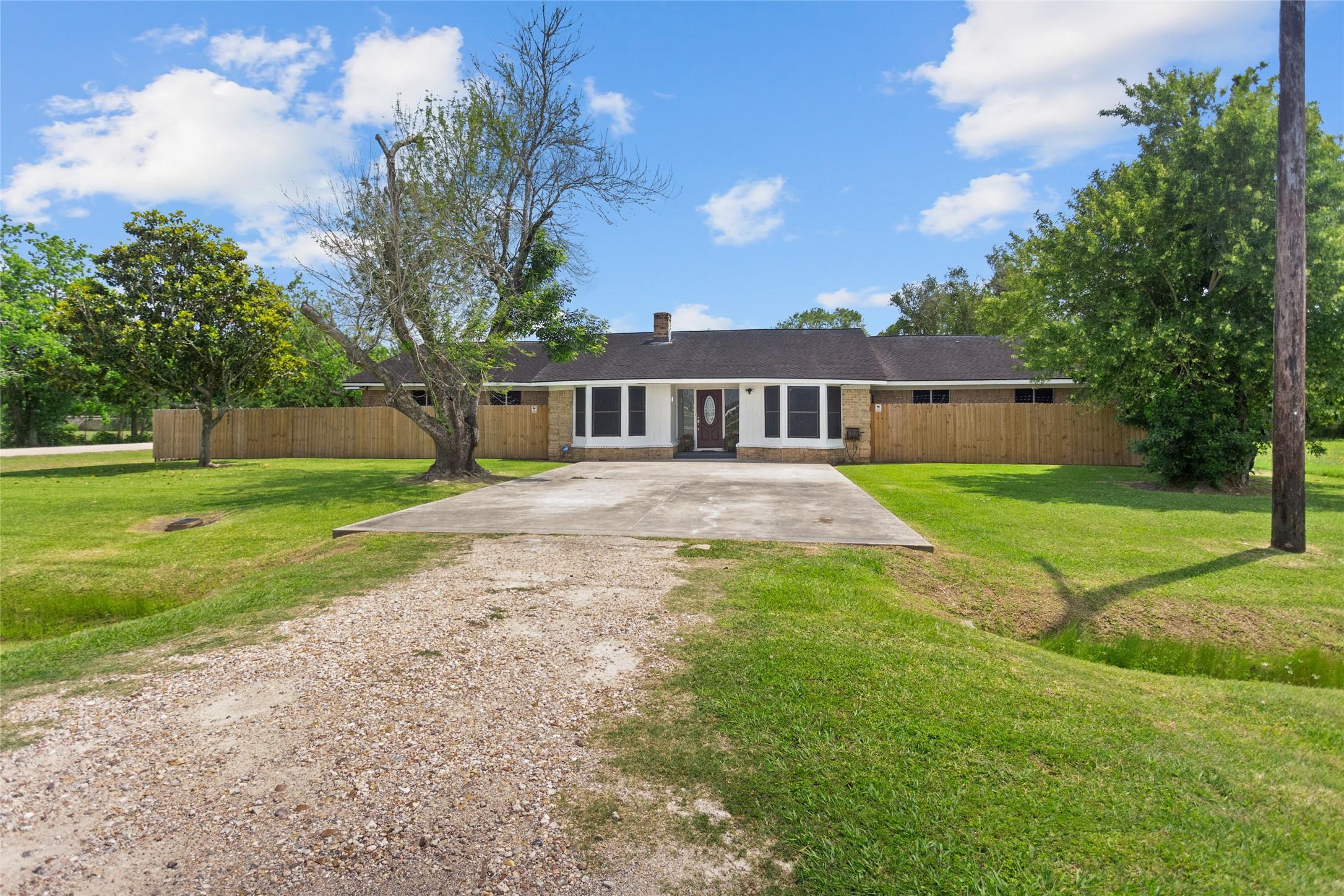 Image 3: Lots of green space in the front of the home and n