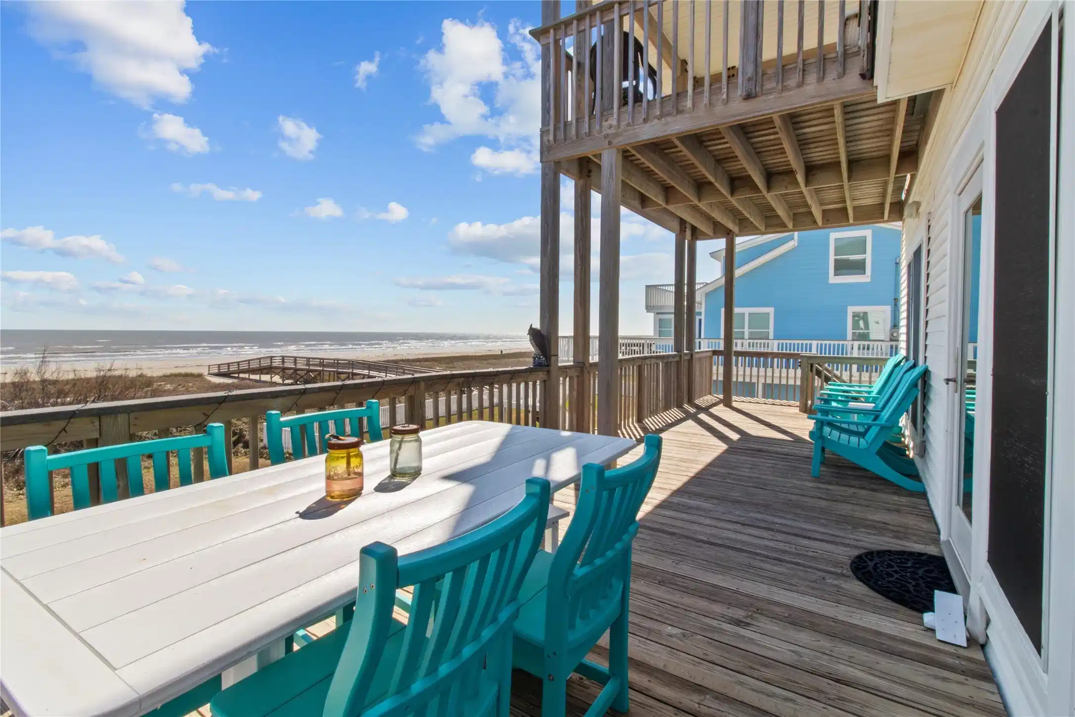 Image 1: Beachfront deck with ocean views, featuring a spac