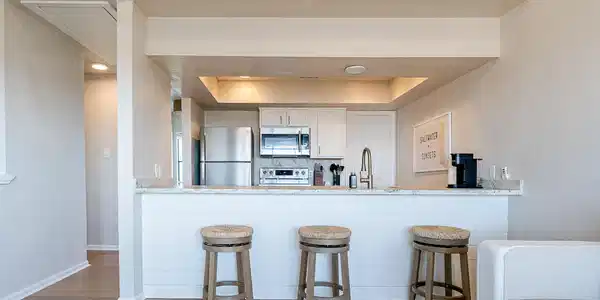 Image 4: Leathered granite counters stainless appliances.