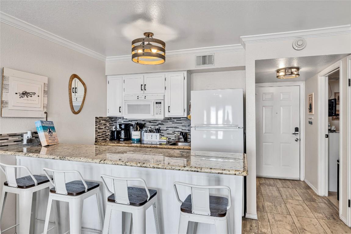 Image 3: Updated kitchen with refrigerator and dishwasher