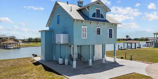 Image 2: An elevated coastal home offers a picturesque wate
