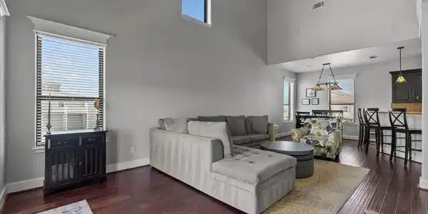 Image 3: This spacious living area features high ceilings a