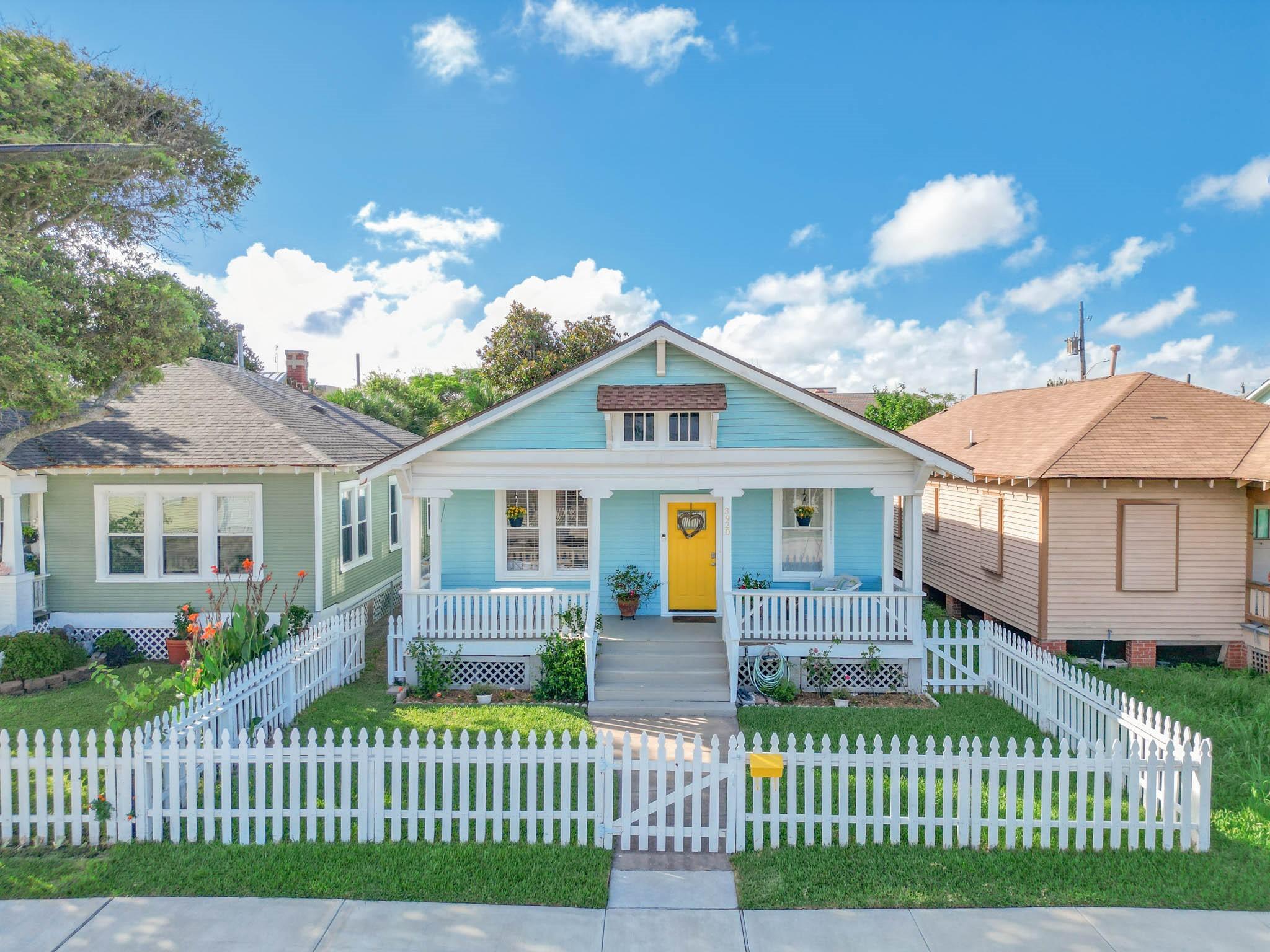 Image 1: Charming single-story home with a welcoming yellow