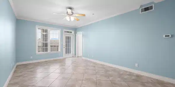 Image 3: Spacious open-concept living area with tile floori