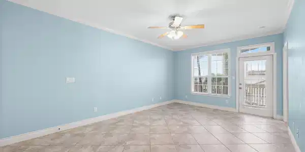 Image 4: Spacious open-concept living area with tile floori