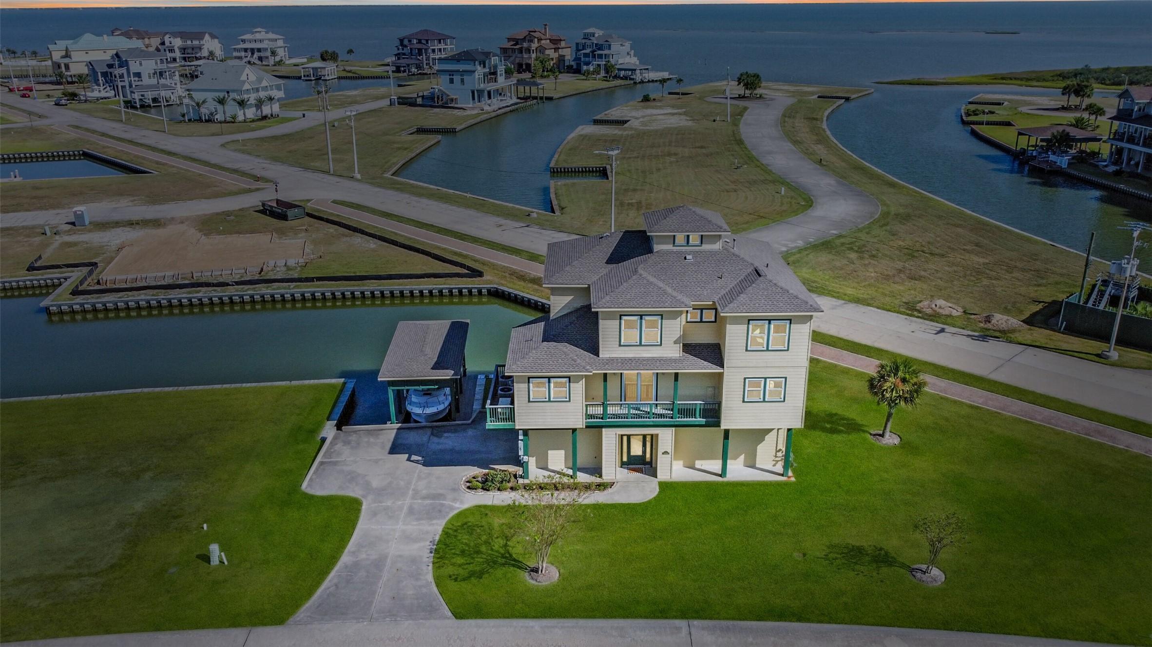 Image 4: Stunning areal view of this coastal home on canal