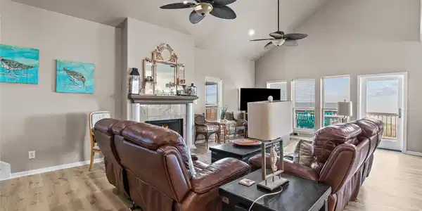 Image 3: This spacious living room features a high ceiling
