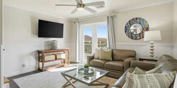 Image 2: This cozy living room features neutral tones and m