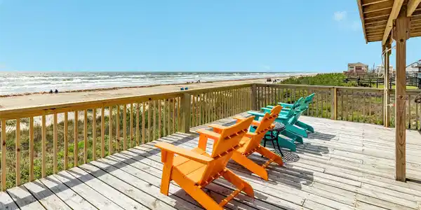 Image 2: Spacious beachfront deck with Adirondack seating o