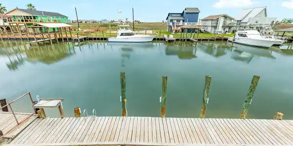 Image 2: A wide deck view showcasing the calm canal and nea