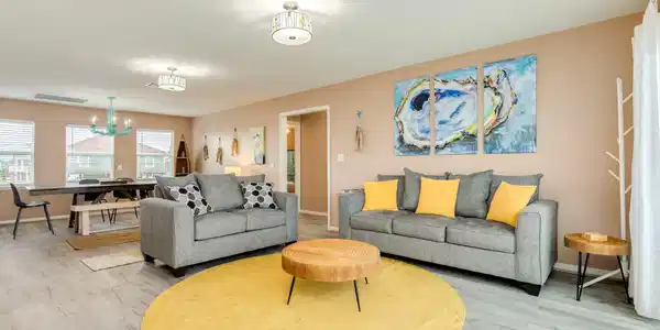 Image 4: This spacious living area features coastal-inspire