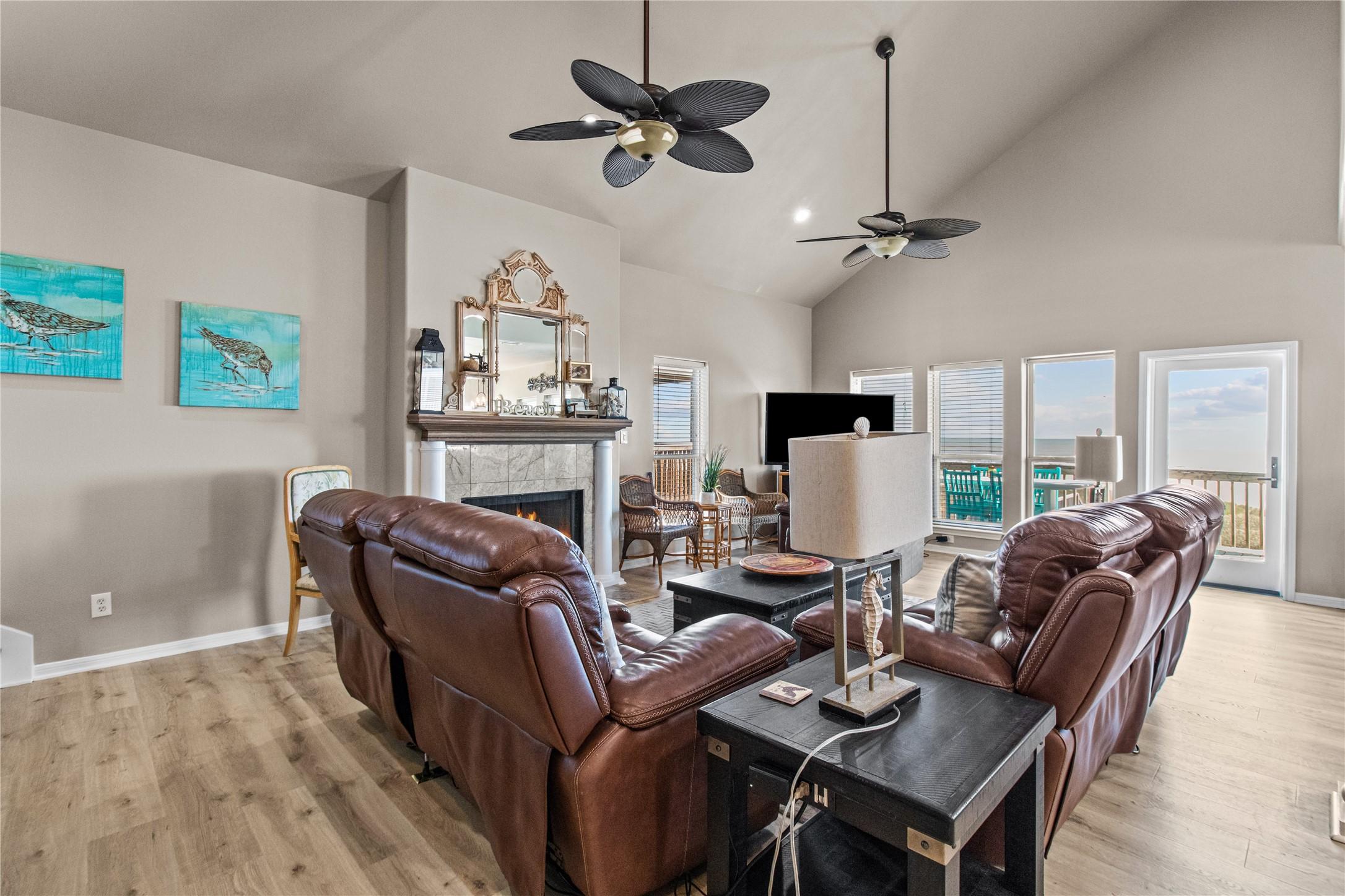 Image 1: This spacious living room features a high ceiling