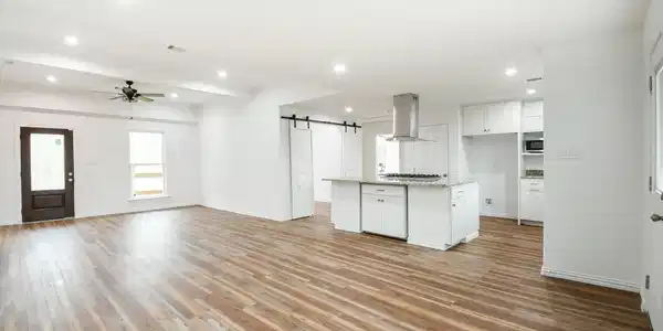 Image 3: Huge living area open to the kitchen.