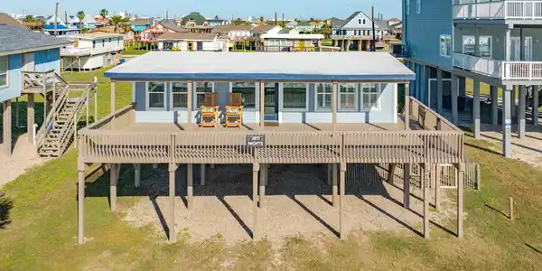 Image 3: Front Exterior &ndash; Elevated coastal home featuring a