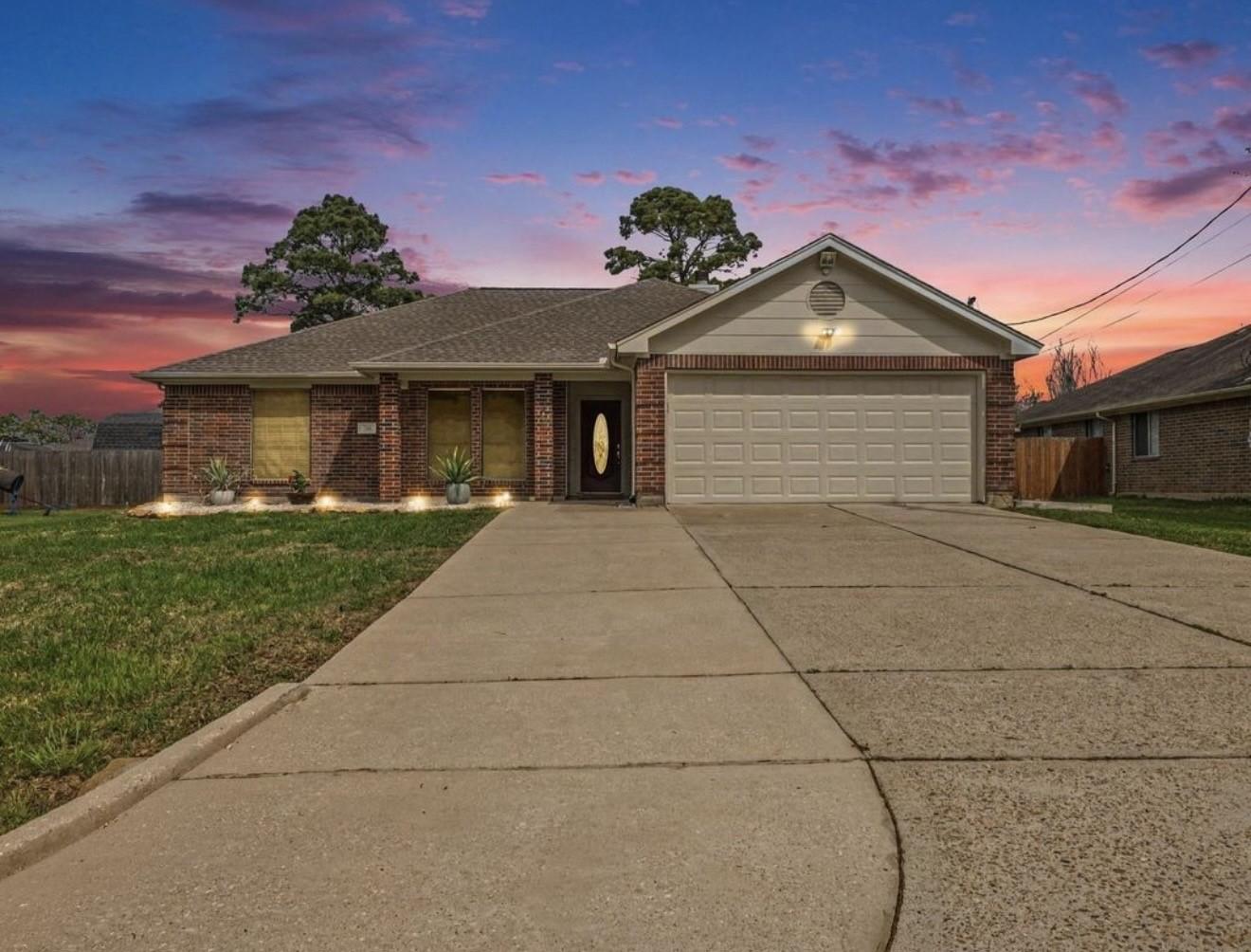 Image 2: The front of the home welcomes you with an extra-w