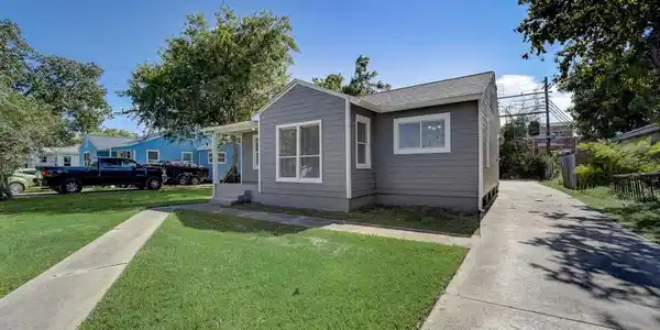 Image 3: The driveway extends to the back of the property a