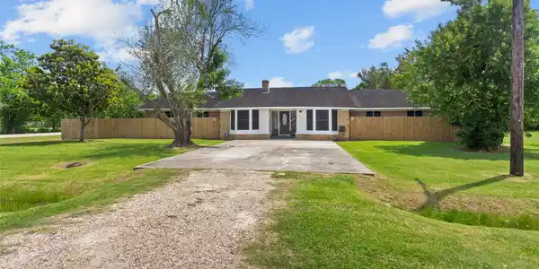 Image 4: Lots of green space in the front of the home and n