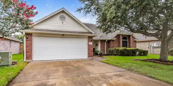 Image 2: Double driveway with 2 car garage.