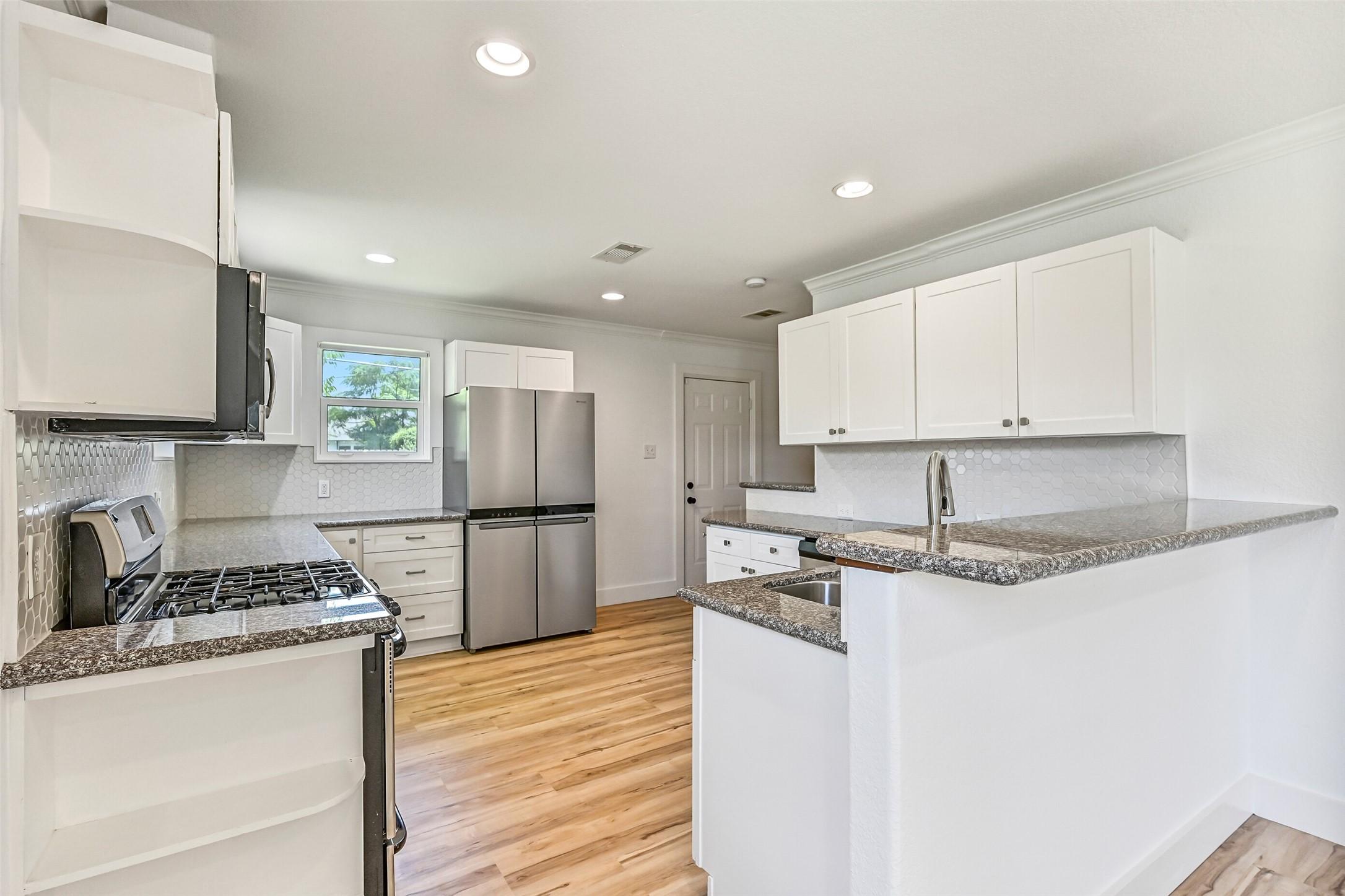 Image 3: The heart of the home is this beautifully updated