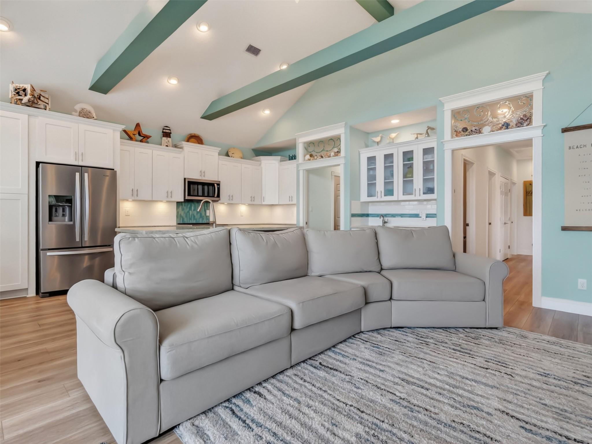 Image 2: This spacious living area features vaulted ceiling