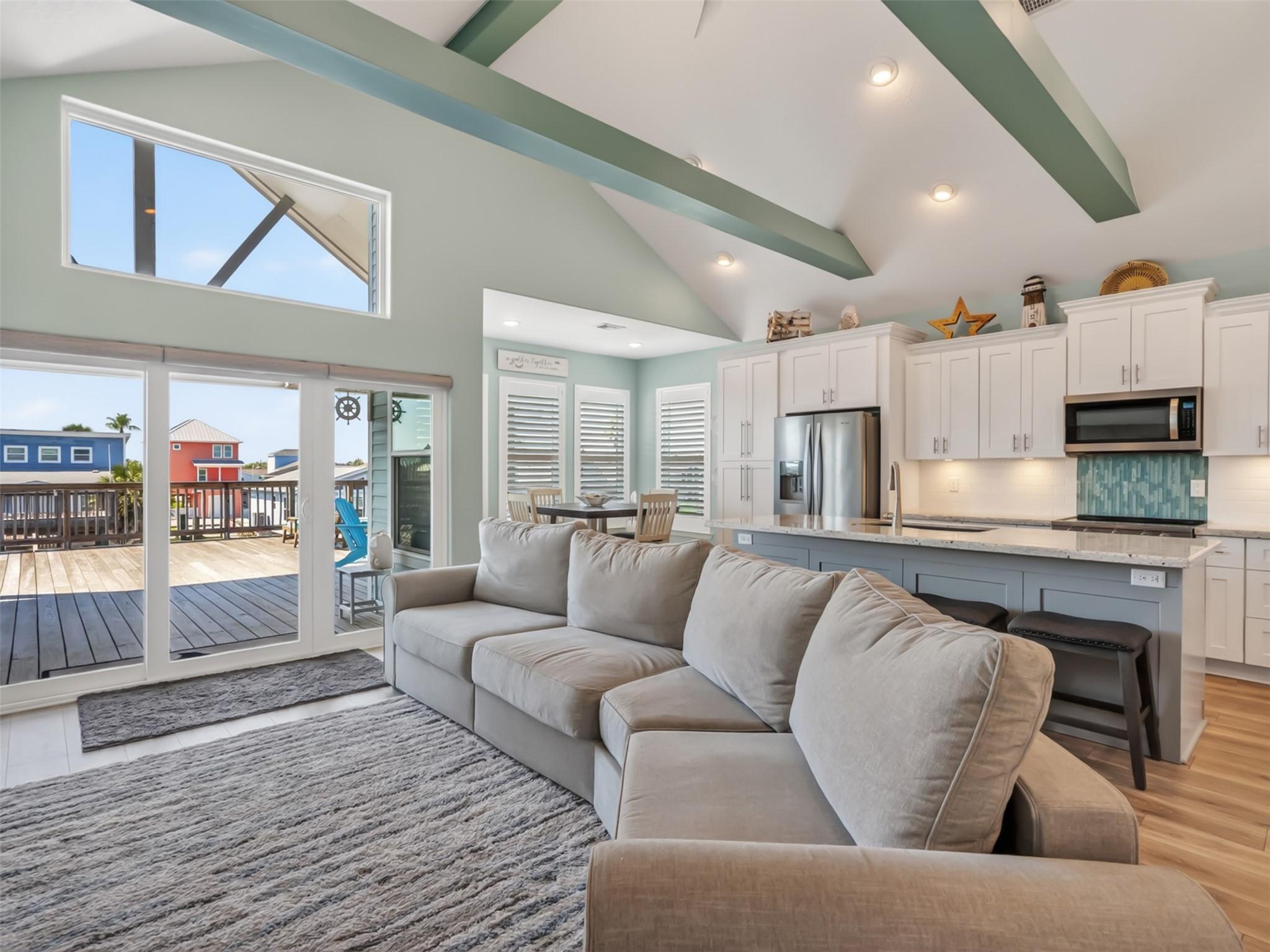 Image 3: The living area has natural light from large windo