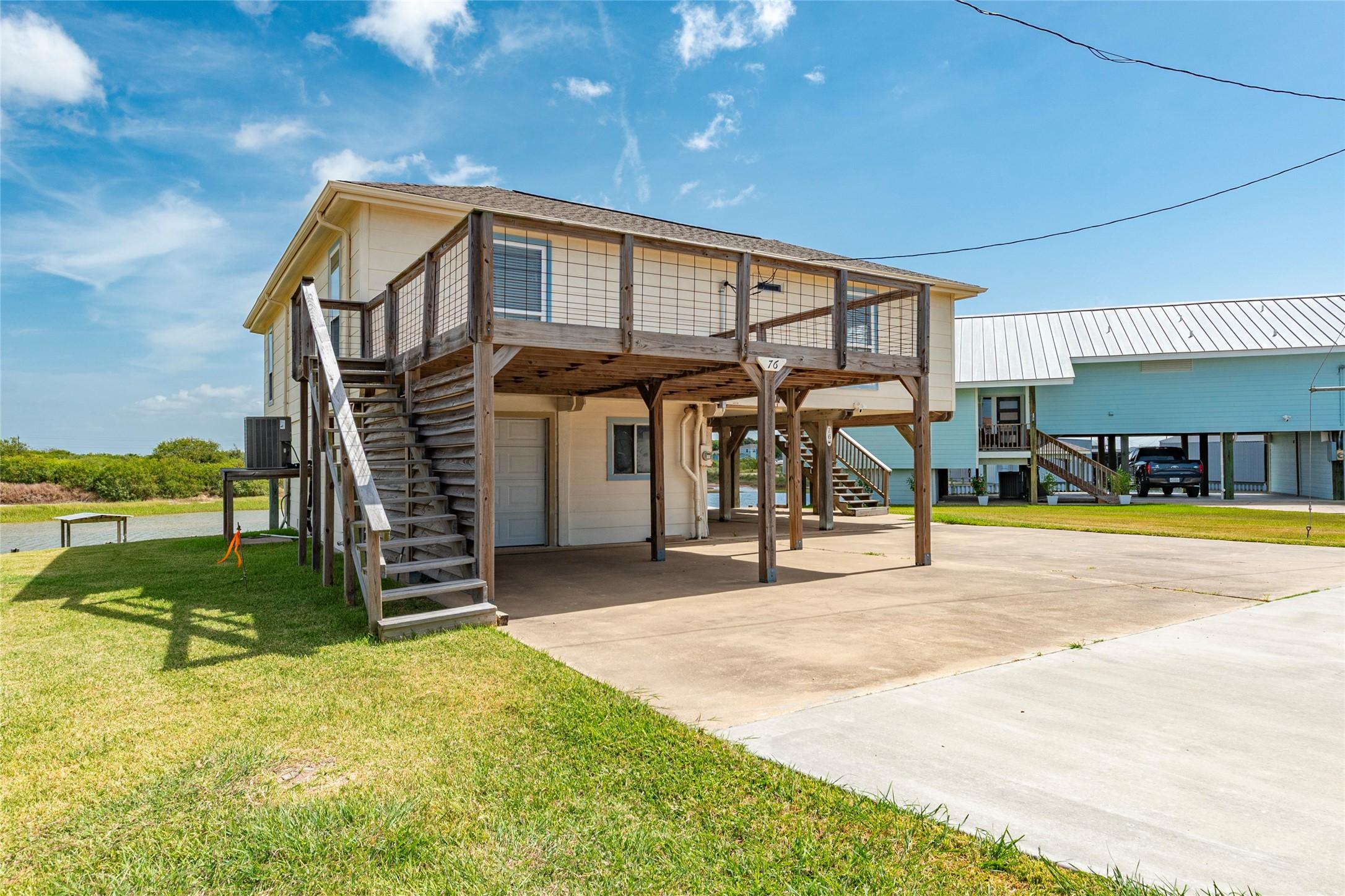 Image 2: This photo features a raised house with a wooden d