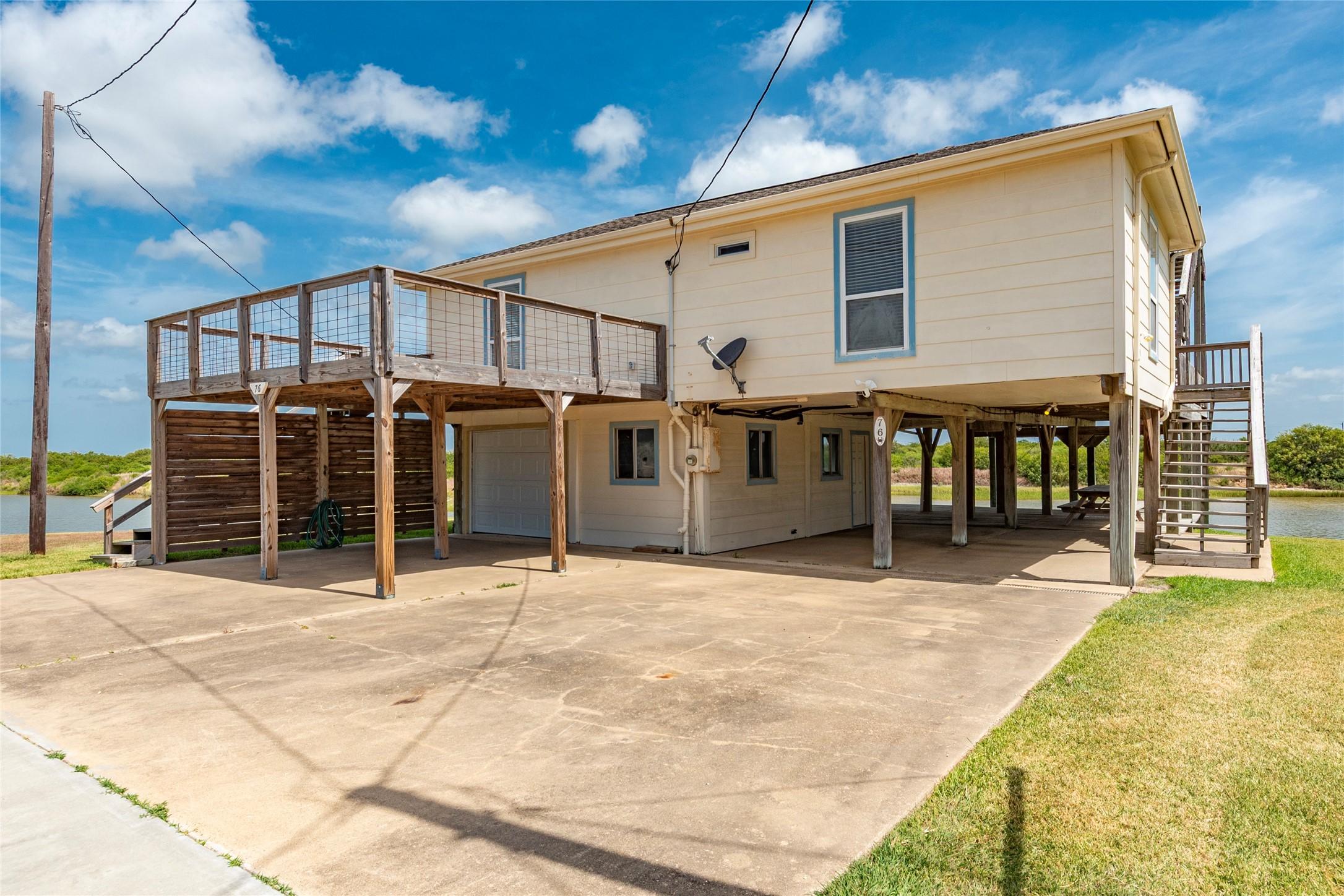 Image 3: Elevated coastal home with a spacious deck, ample