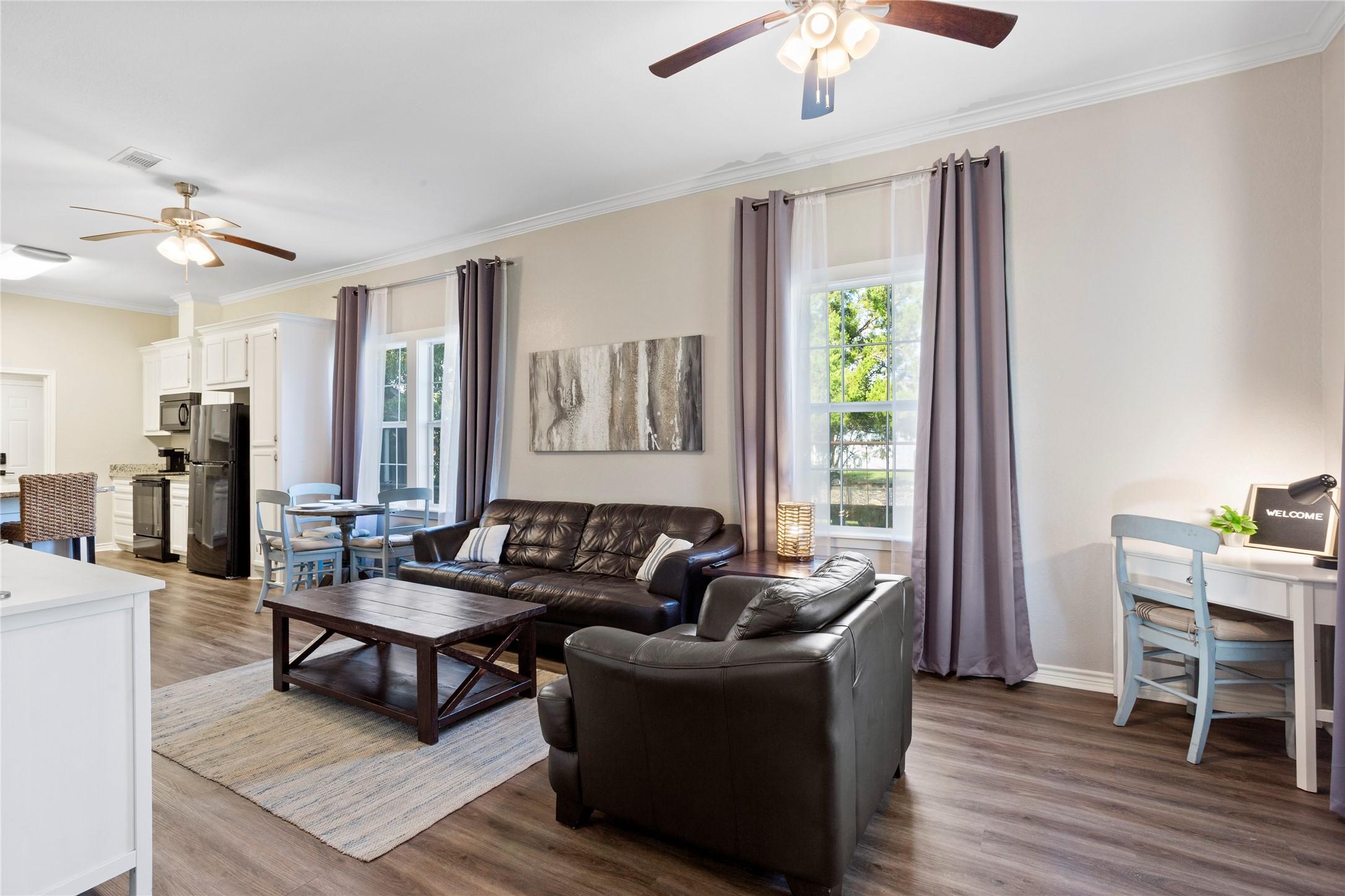 Image 3: The open-concept living room, dining area, and lar