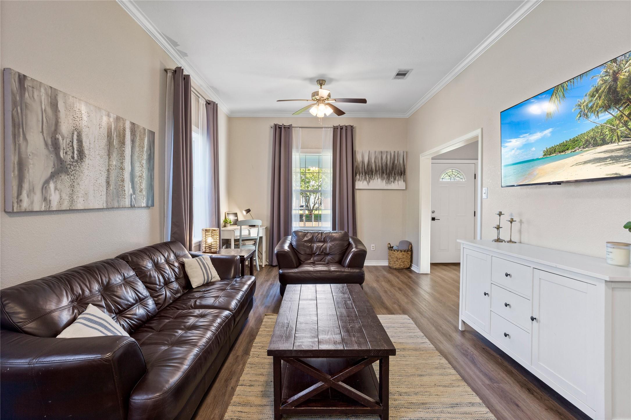 Image 4: Spacious living room with LVP flooring & crown mol