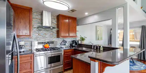 Image 4: SS appliances.  Gas cooktop, double electric oven