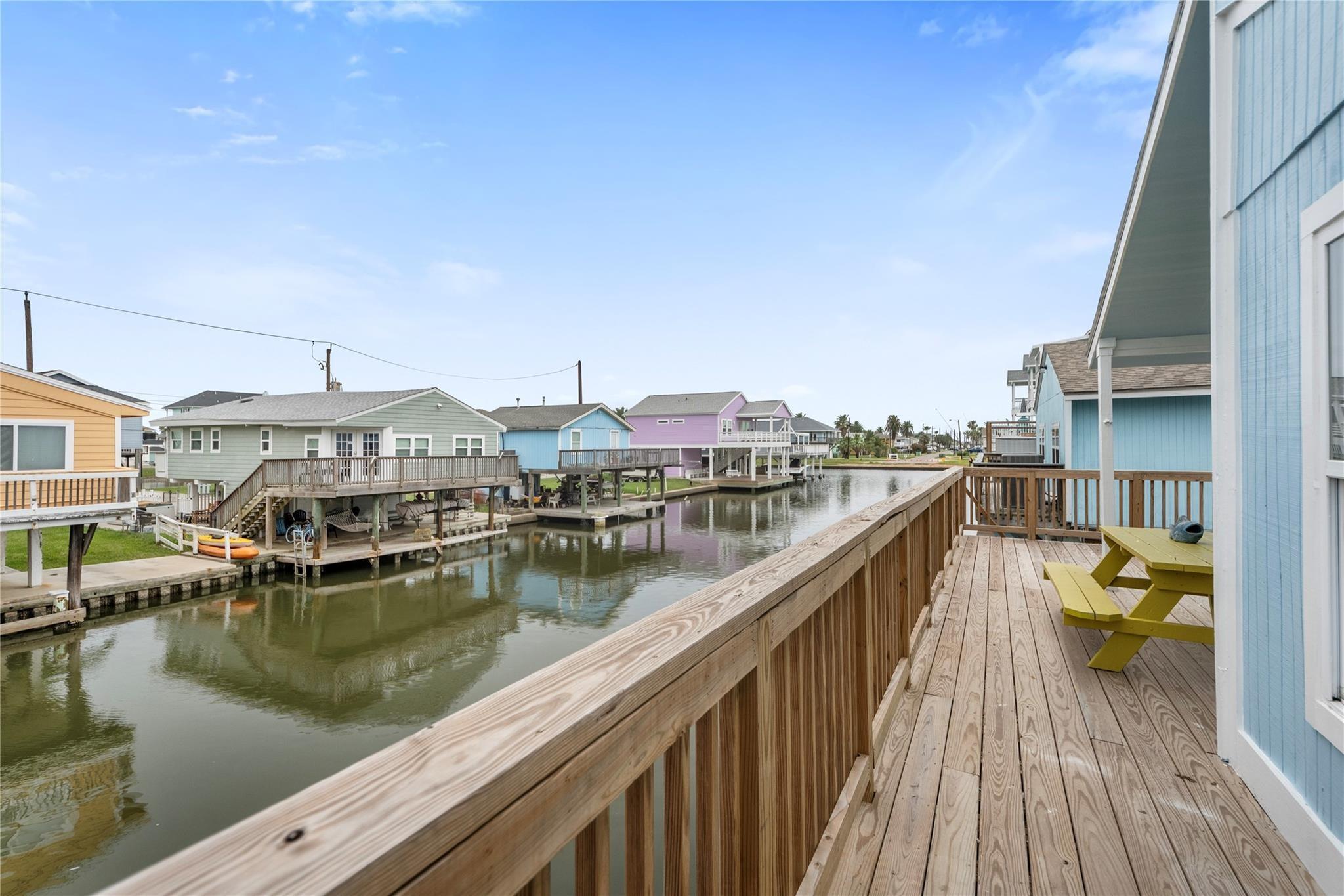 Image 1: An inviting coastal-style home elevated on stilts