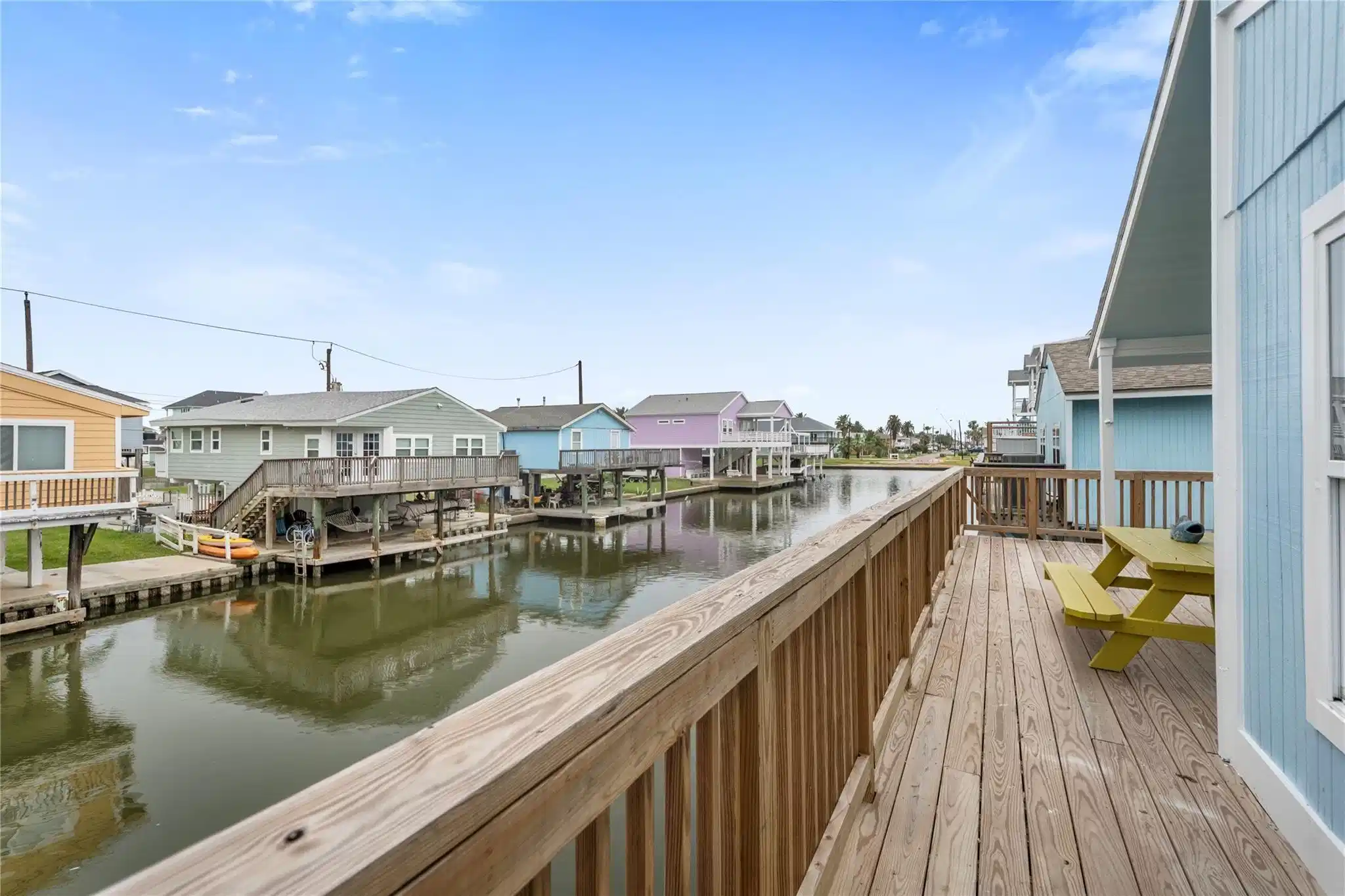 Image 1: An inviting coastal-style home elevated on stilts