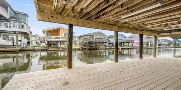 Image 4: An inviting coastal-style home elevated on stilts