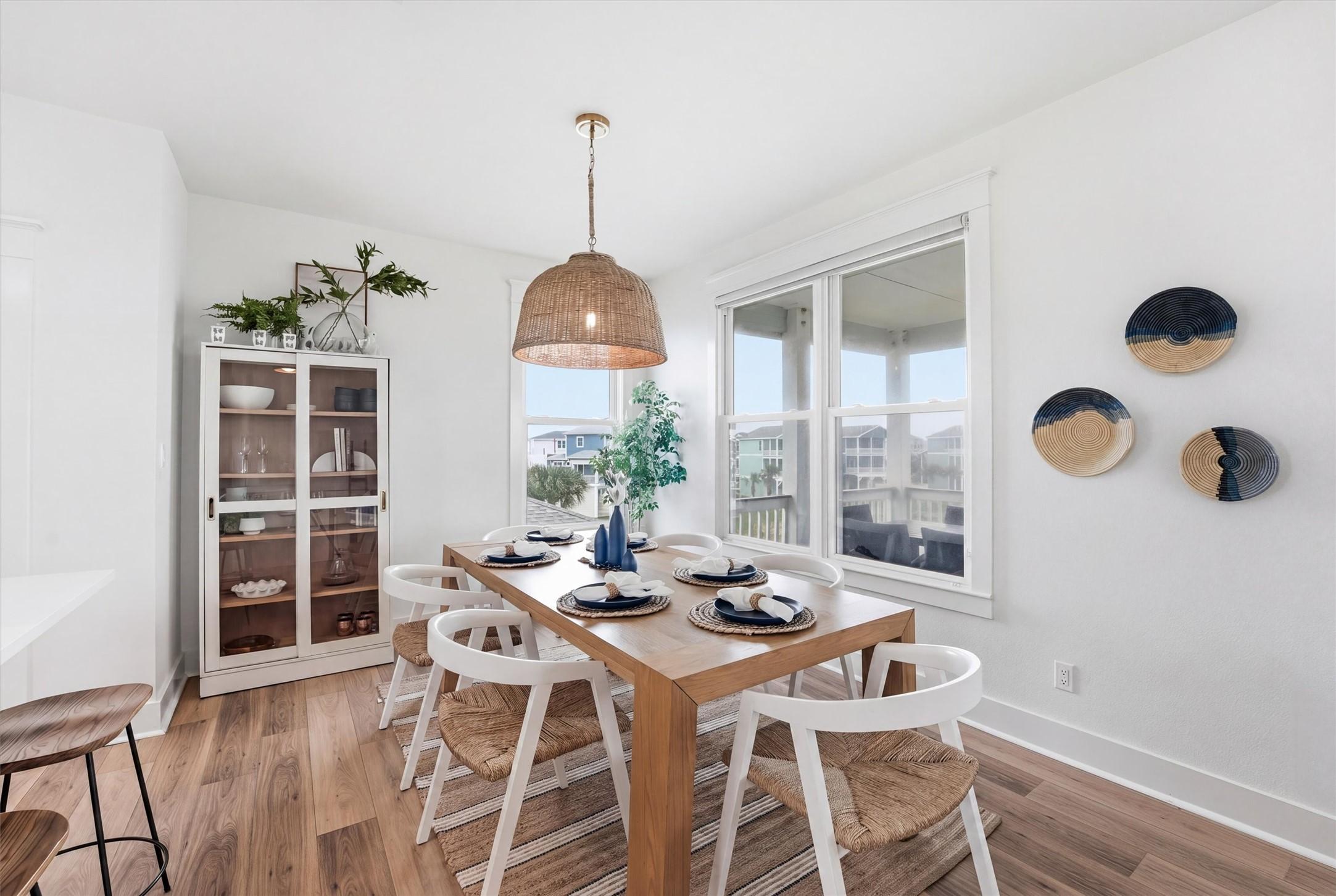 Image 3: Bright dining area with coastal inspired finishes,