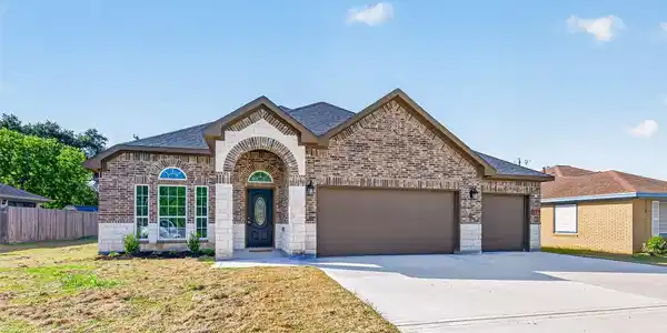 Image 2: Charming single-story brick home with a classic ar