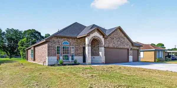 Image 3: Charming brick home featuring a spacious two-car g