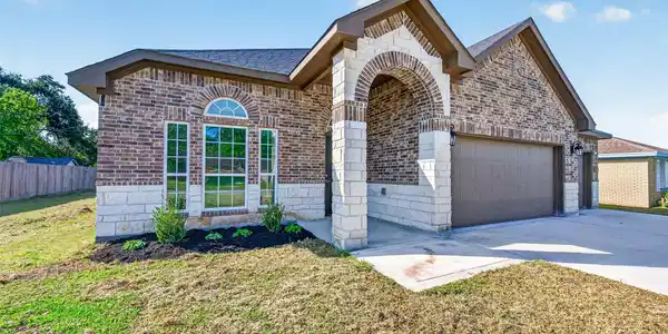 Image 4: Charming brick home with a welcoming arched entryw