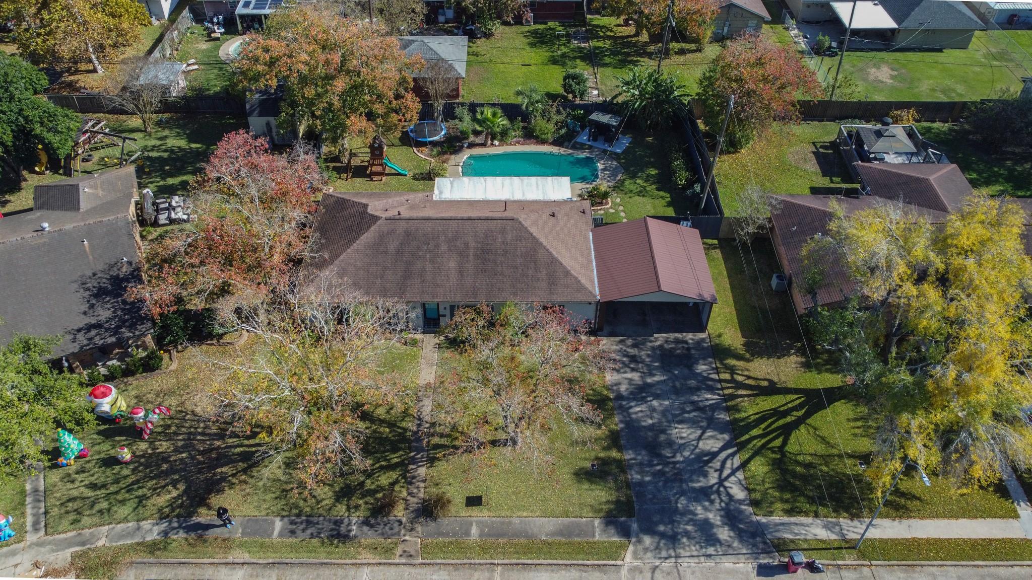 Image 2: Aerial view of home and pool