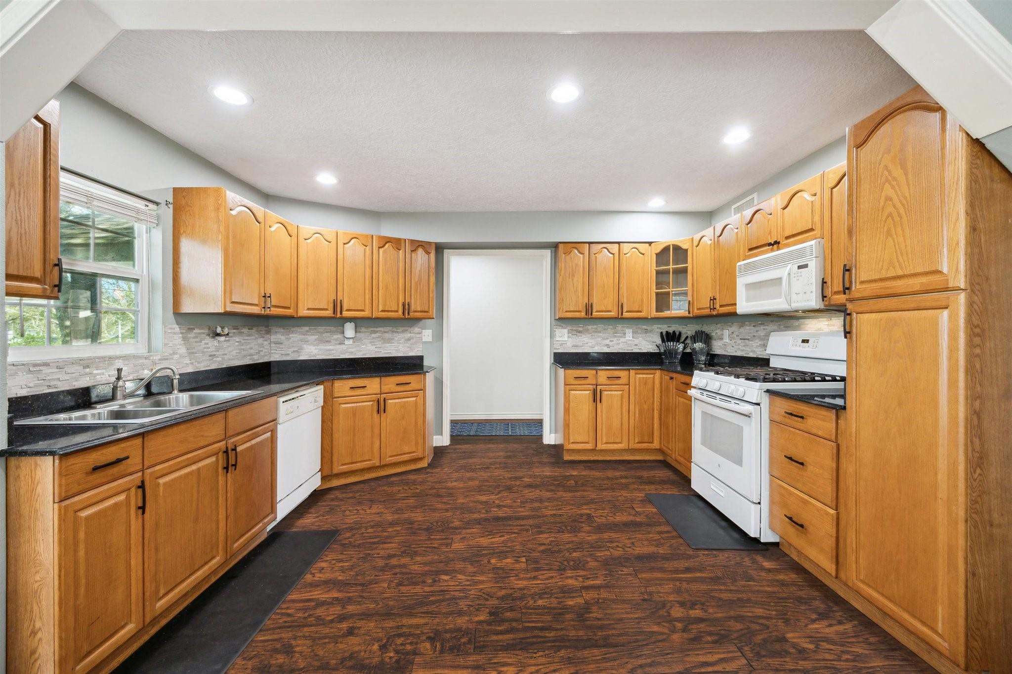 Image 2: Spacious kitchen featuring abundant cabinet storag