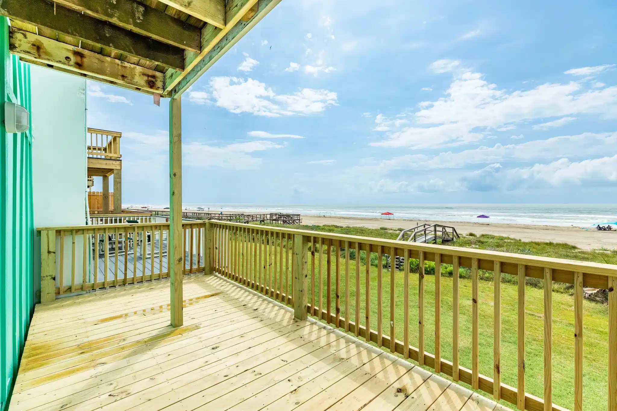 Image 1: Spacious beachfront deck with stunning ocean views