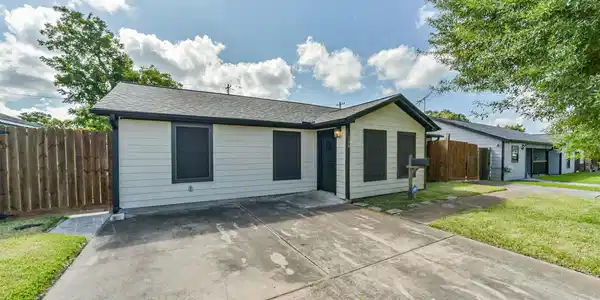 Image 3: Singe-story home with a clean, modern exterior, fe