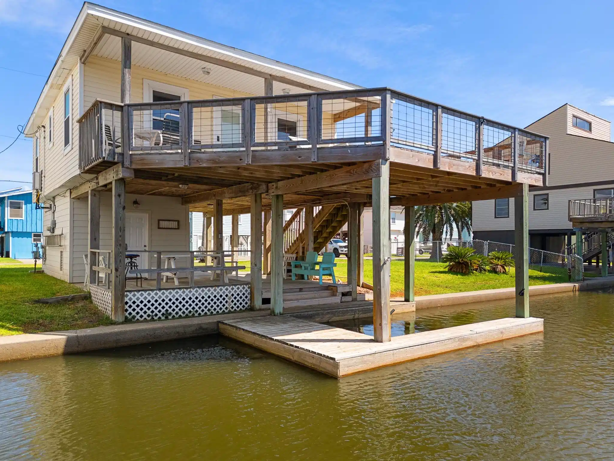 Image 1: This charming waterfront home features an elevated