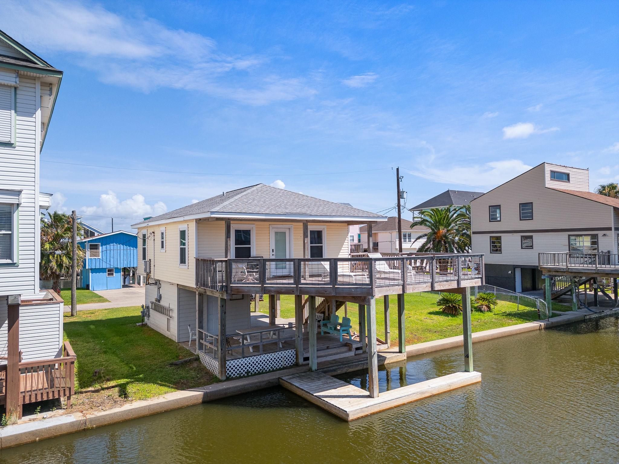 Image 3: This waterfront home features a raised deck with d