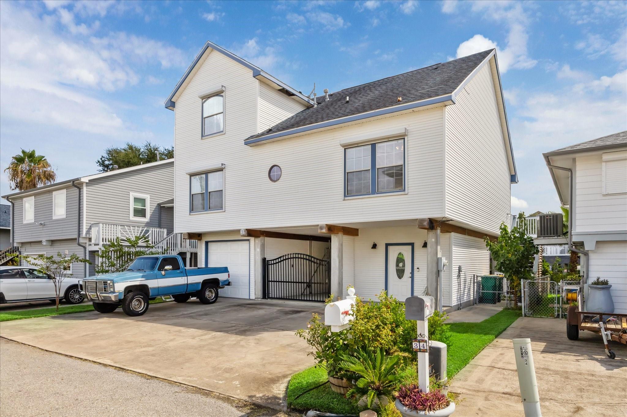 Image 2: This bayfront home features storm shutters on the