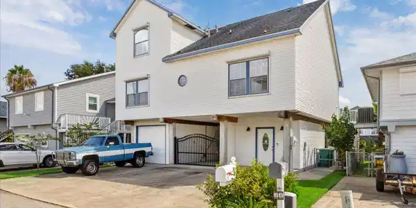Image 2: This bayfront home features storm shutters on the